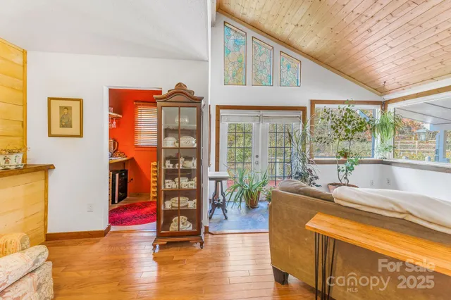 a living room with furniture and a floor to ceiling window