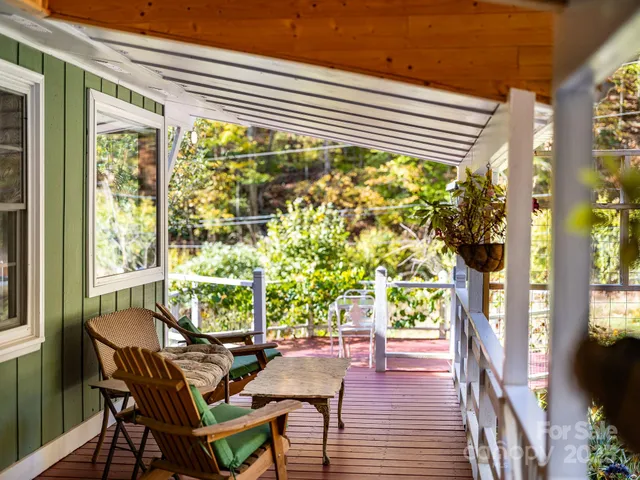 a view of a patio with a table and chairs next to a yard