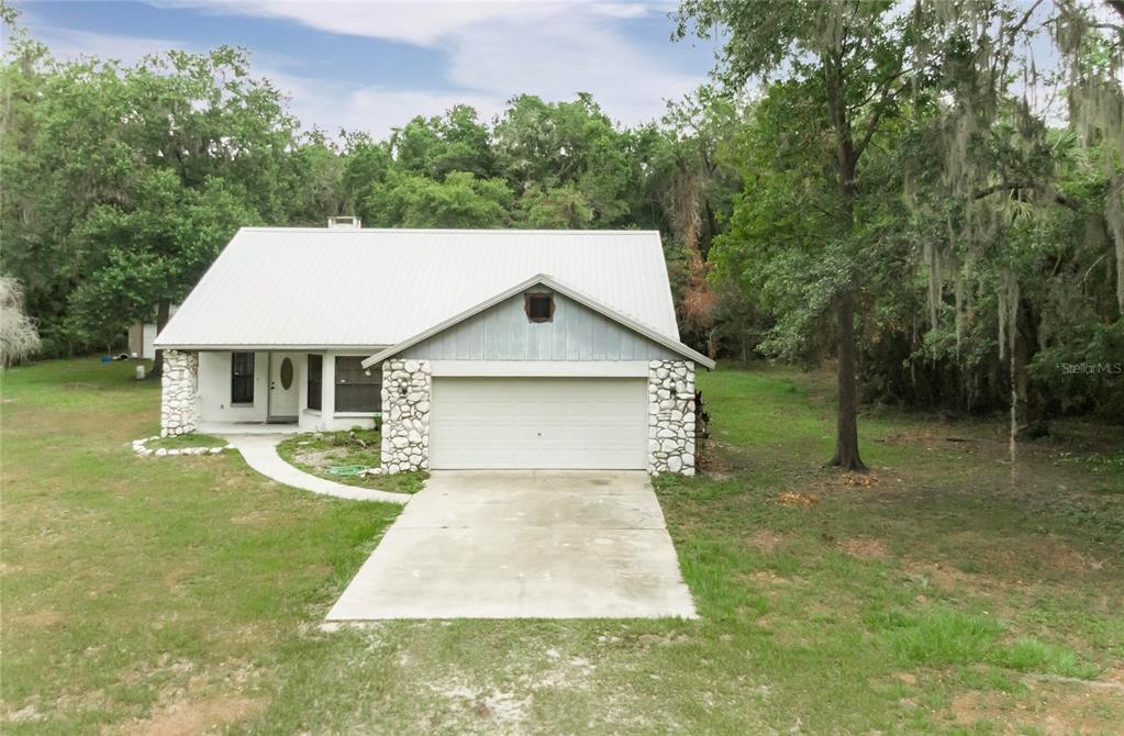 a front view of house with yard and green space