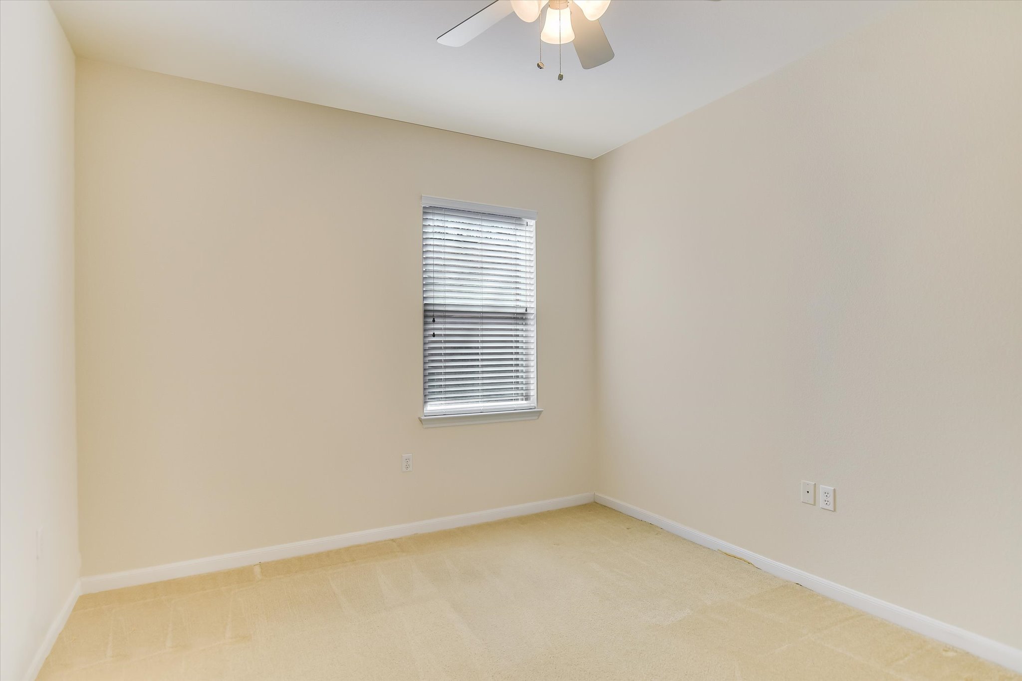 418 Monarch Trail Georgetown, TX 78633 - Photo 18 of 24 an empty room with a chandelier fan and windows
