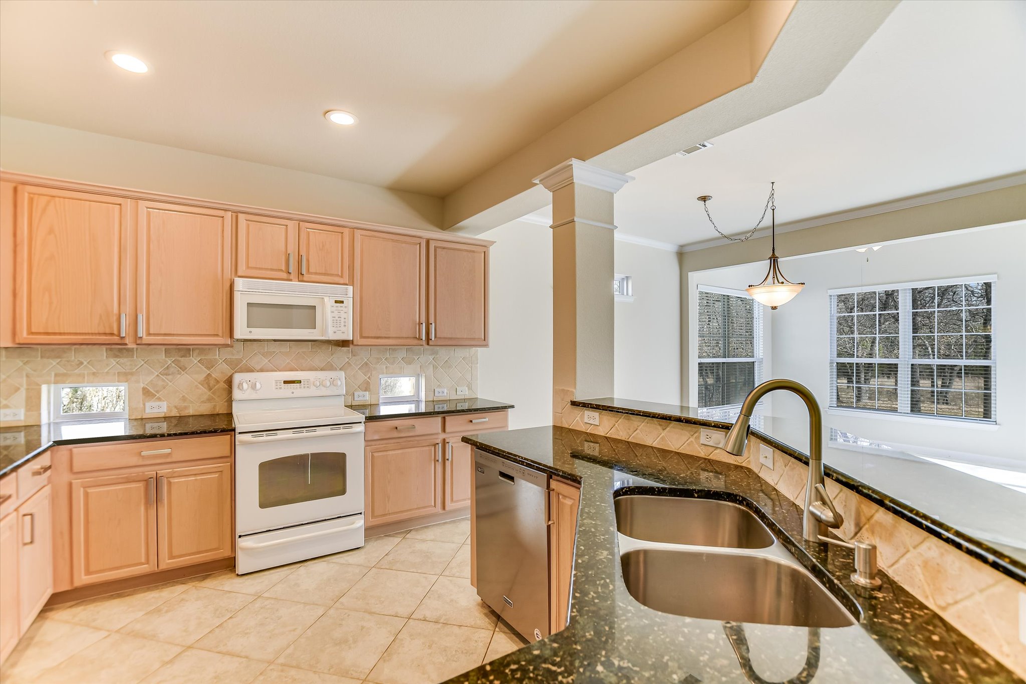 418 Monarch Trail Georgetown, TX 78633 - Photo 9 of 24 a kitchen with granite countertop a sink stainless steel appliances and cabinets
