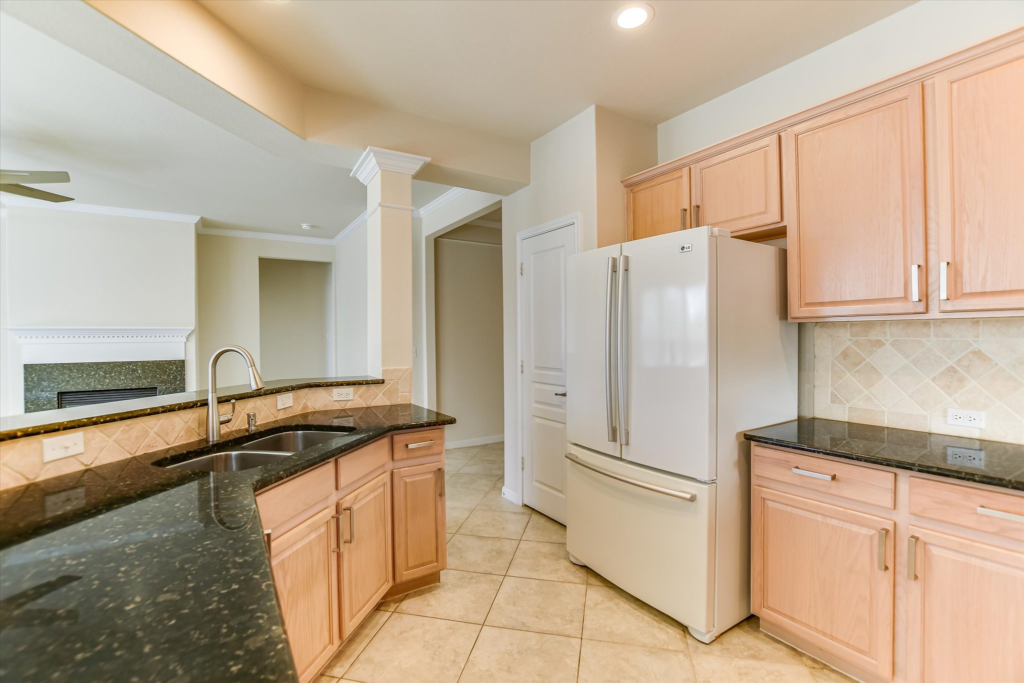 418 Monarch Trail Georgetown, TX 78633 - Photo 10 of 24 a kitchen with granite countertop a refrigerator and a sink