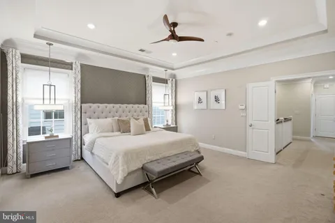 a spacious bedroom with a bed and a flat screen tv