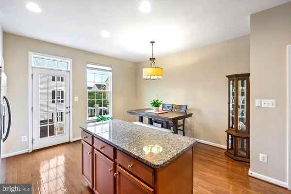 a view of a kitchen area with furniture and wooden floor