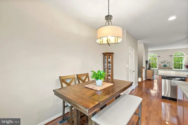 a view of a dining room with a table and chairs
