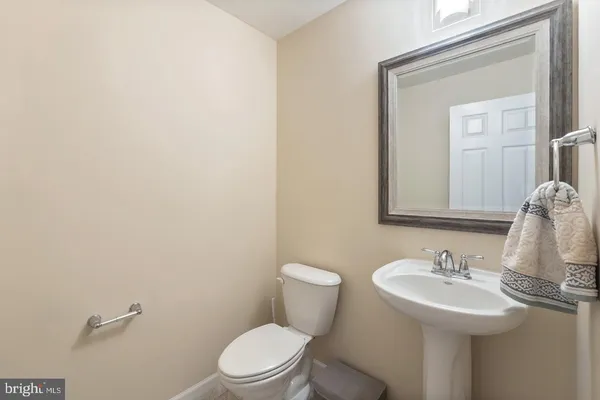 a bathroom with a sink a toilet and mirror