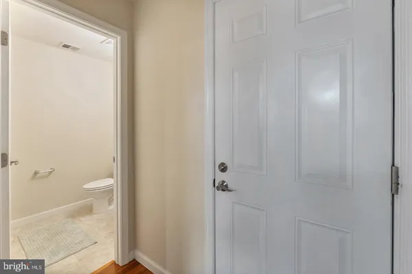 a bathroom with a granite countertop shower and a toilet