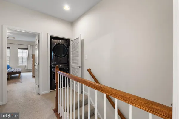 a view of hallway with livingroom and furniture