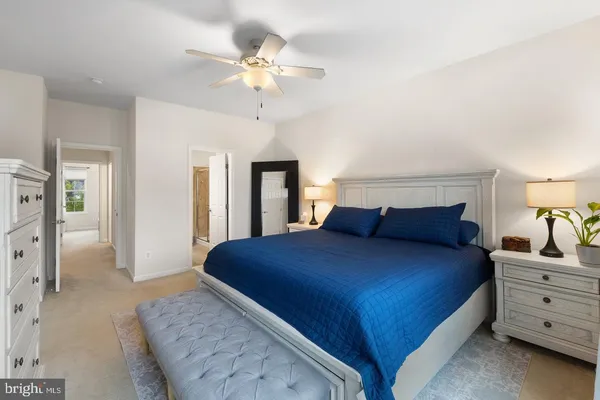 a bedroom with a large bed and a chandelier