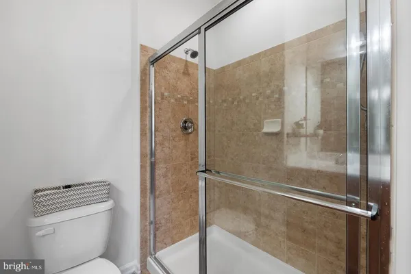 a bathroom with a shower and toilet