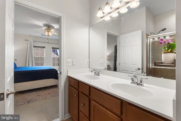 a en suite bathroom with a double vanity sink and a mirror