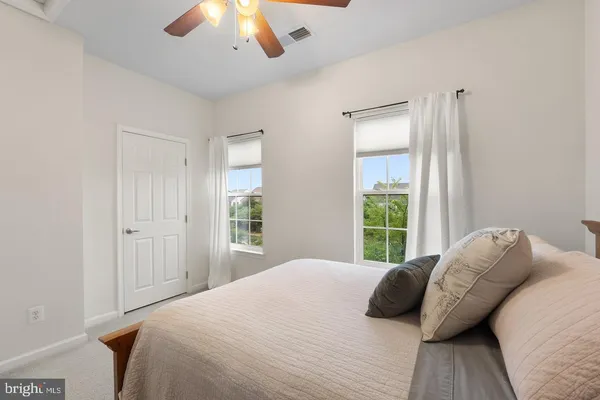 a bedroom with a bed and a large window