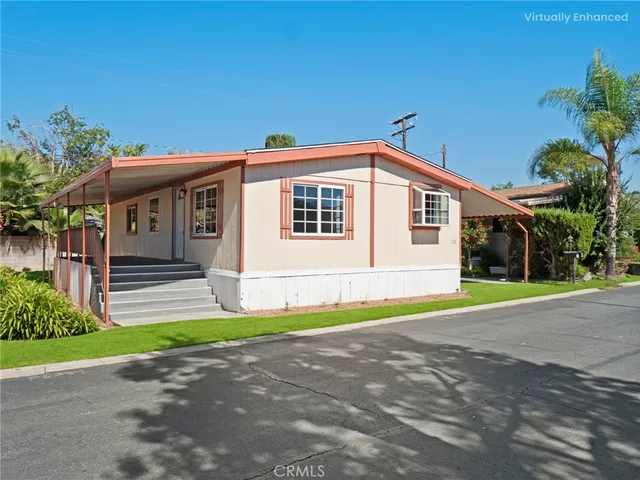 a front view of a house with a garden and yard