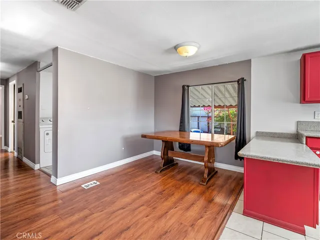 a kitchen with a refrigerator sink and wooden cabinets