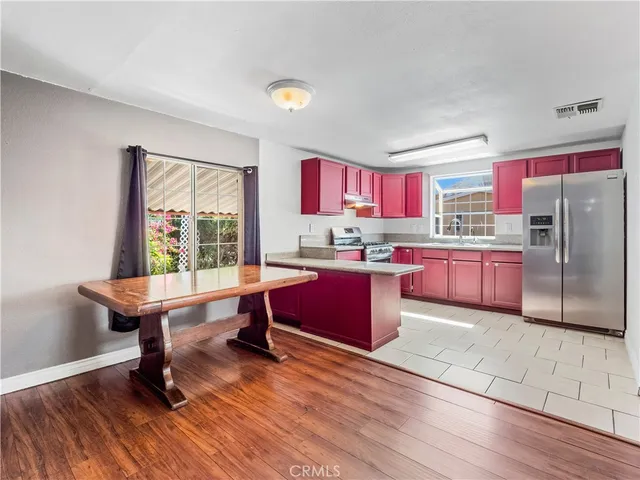 a kitchen with stainless steel appliances granite countertop a stove a sink dishwasher and a microwave oven with cabinets