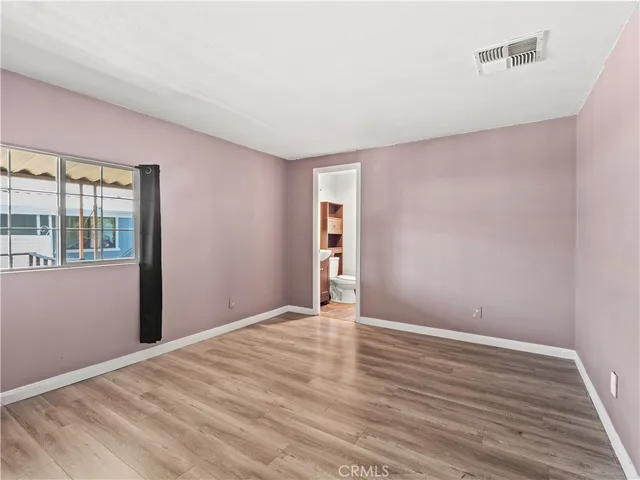 a view of wooden floor and windows in a room