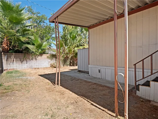 a view of a backyard with a large tree