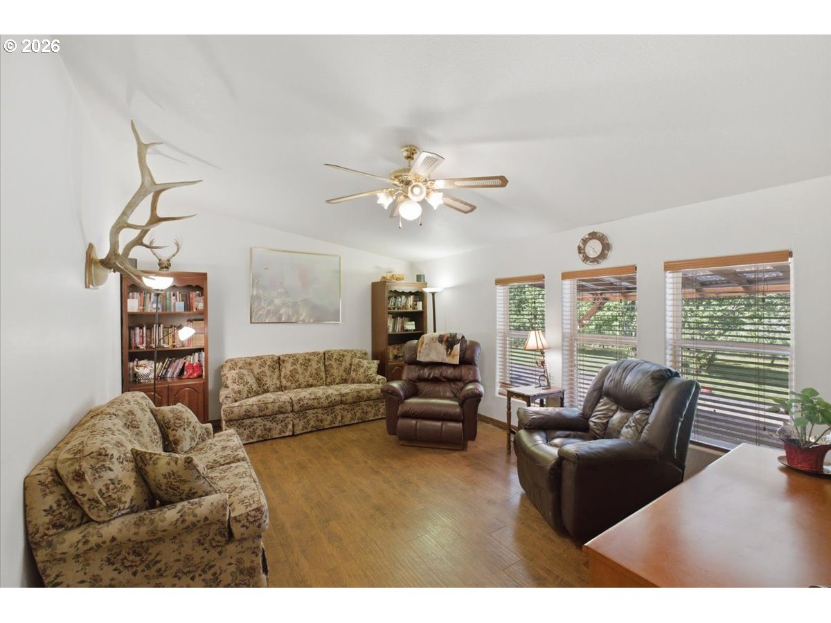 35377 Ede Road Lebanon, OR 97355 - Photo 14 of 48 a living room with furniture ceiling fan and a large window