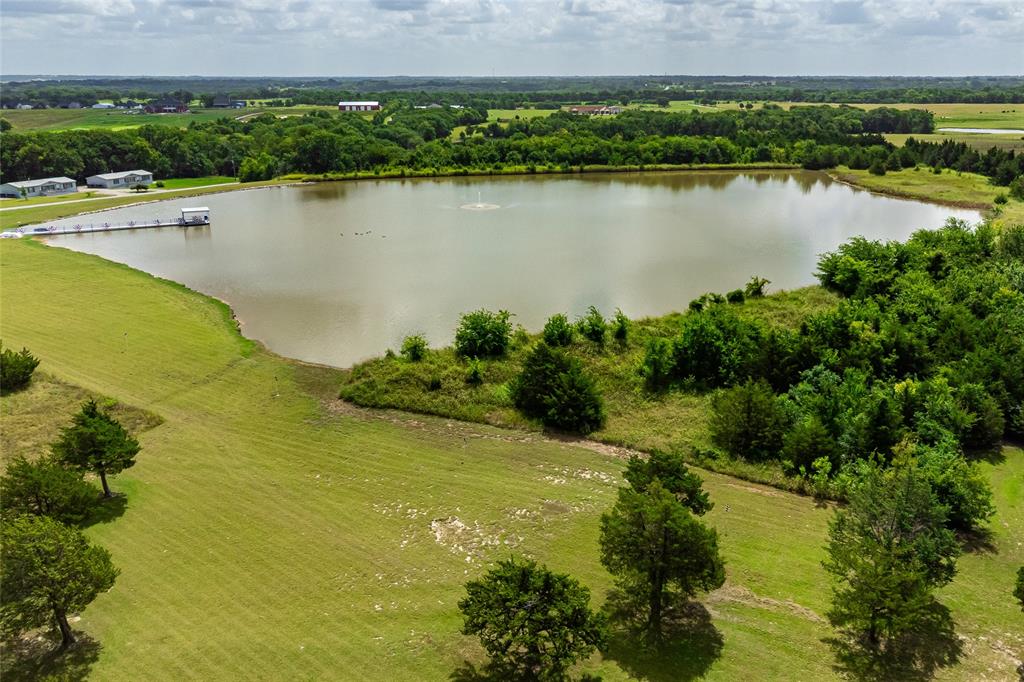 Arial view of Lake Santa Maria which is approximately 40 feet deep at the center, 25 feet deep rip rap shoreline and average depth of 15 feet.  This 10-acre lake is an attractive showstopper with the fountain spray and trees in the background.
