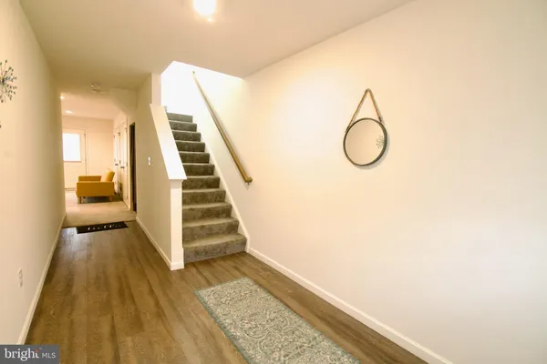 a view of a room with furniture and a ceiling fan