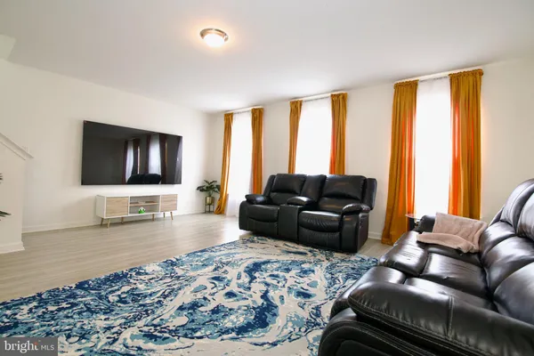 a kitchen with stainless steel appliances granite countertop a table chairs sink refrigerator and microwave