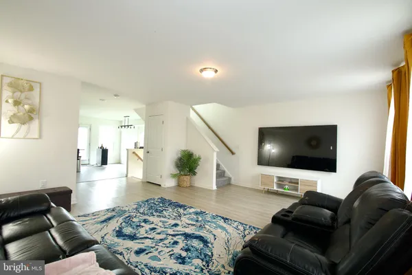 a kitchen with stainless steel appliances kitchen island granite countertop a sink refrigerator and cabinets