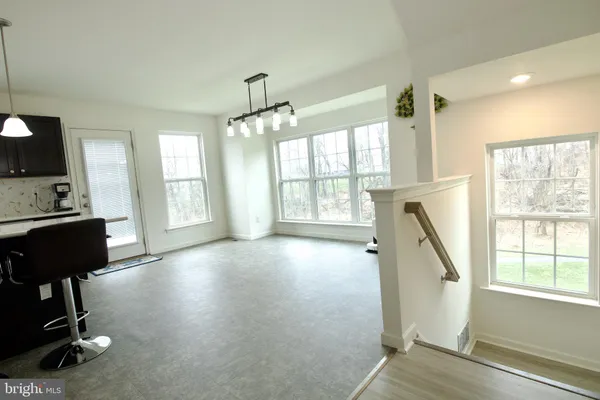 a kitchen with stainless steel appliances granite countertop a sink a stove and a refrigerator