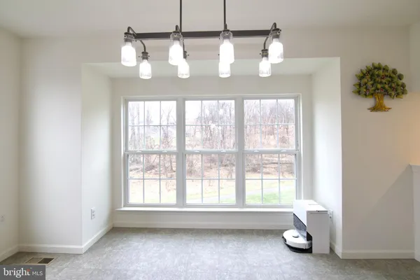 a kitchen with stainless steel appliances granite countertop a sink dishwasher a stove top oven a refrigerator with island and chairs