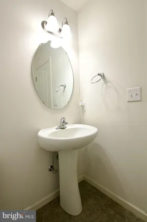 a bedroom with a bed and a mirror on the dresser
