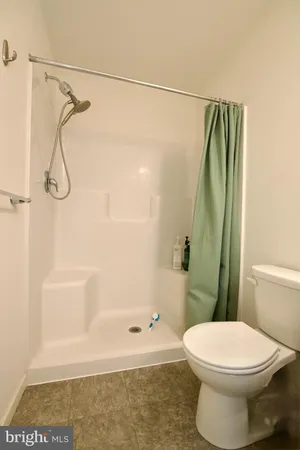 a bedroom with a bed and a night stand