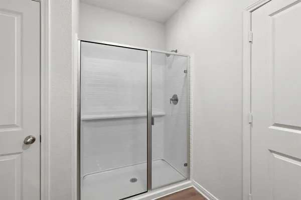 a bathroom with a glass shower door