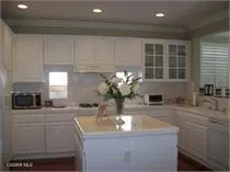 a kitchen with kitchen island a sink appliances and cabinets
