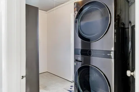 a close view of a utility room with dryer and washer