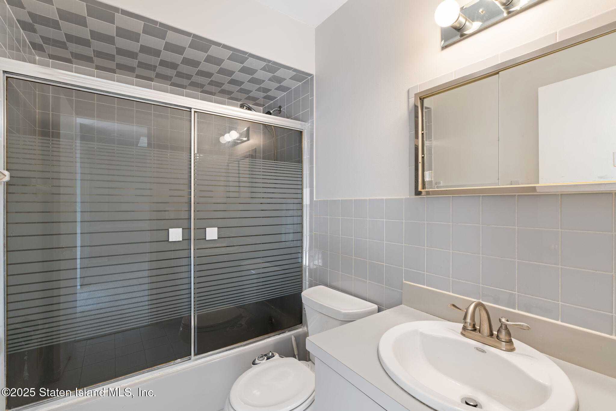 8 Dreyer Avenue, Unit A Staten Island, NY 10314 - Photo 20 of 23 a bathroom with a sink mirror toilet and shower