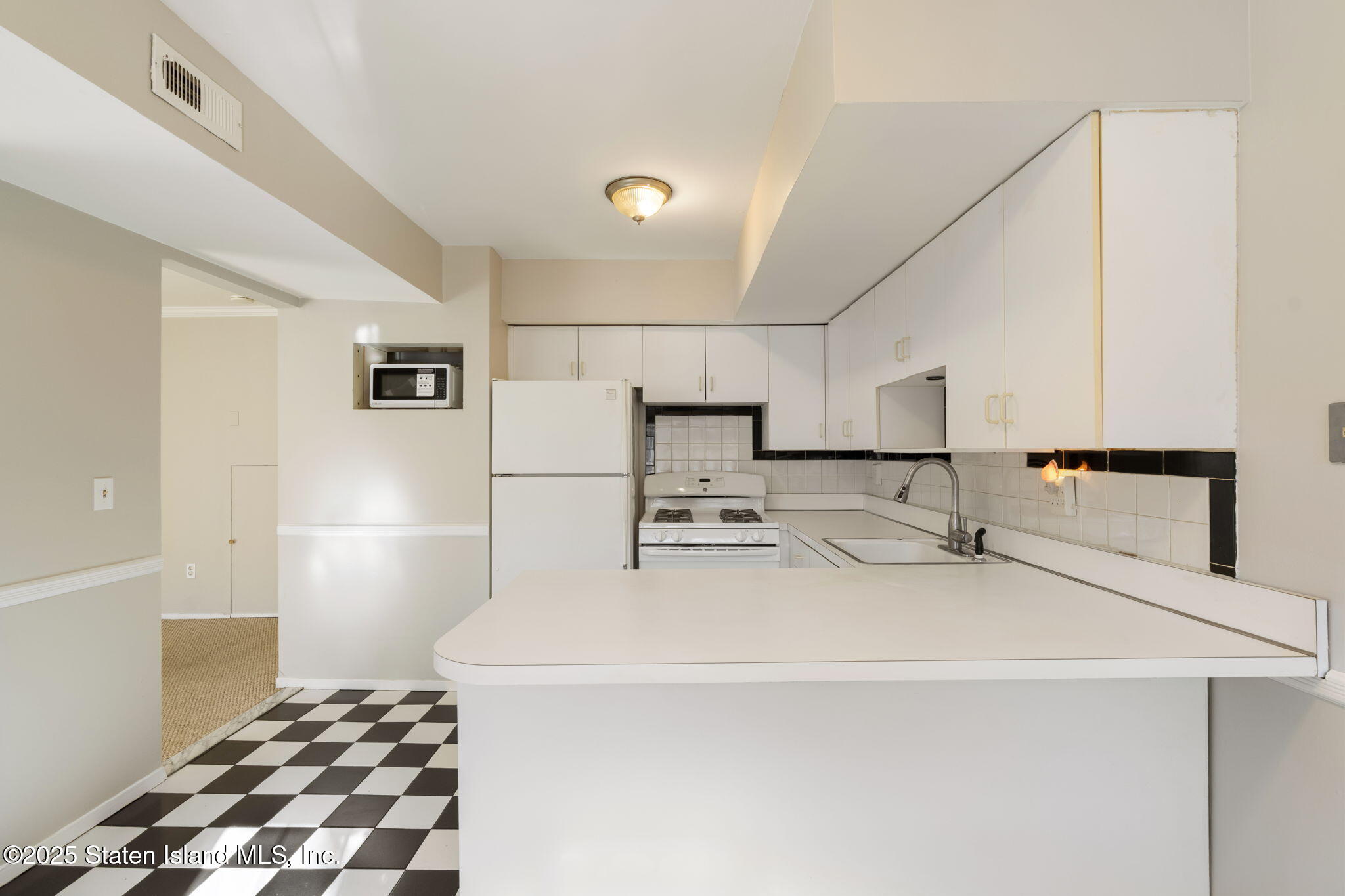 8 Dreyer Avenue, Unit A Staten Island, NY 10314 - Photo 5 of 23 a kitchen with stainless steel appliances granite countertop a sink and a refrigerator