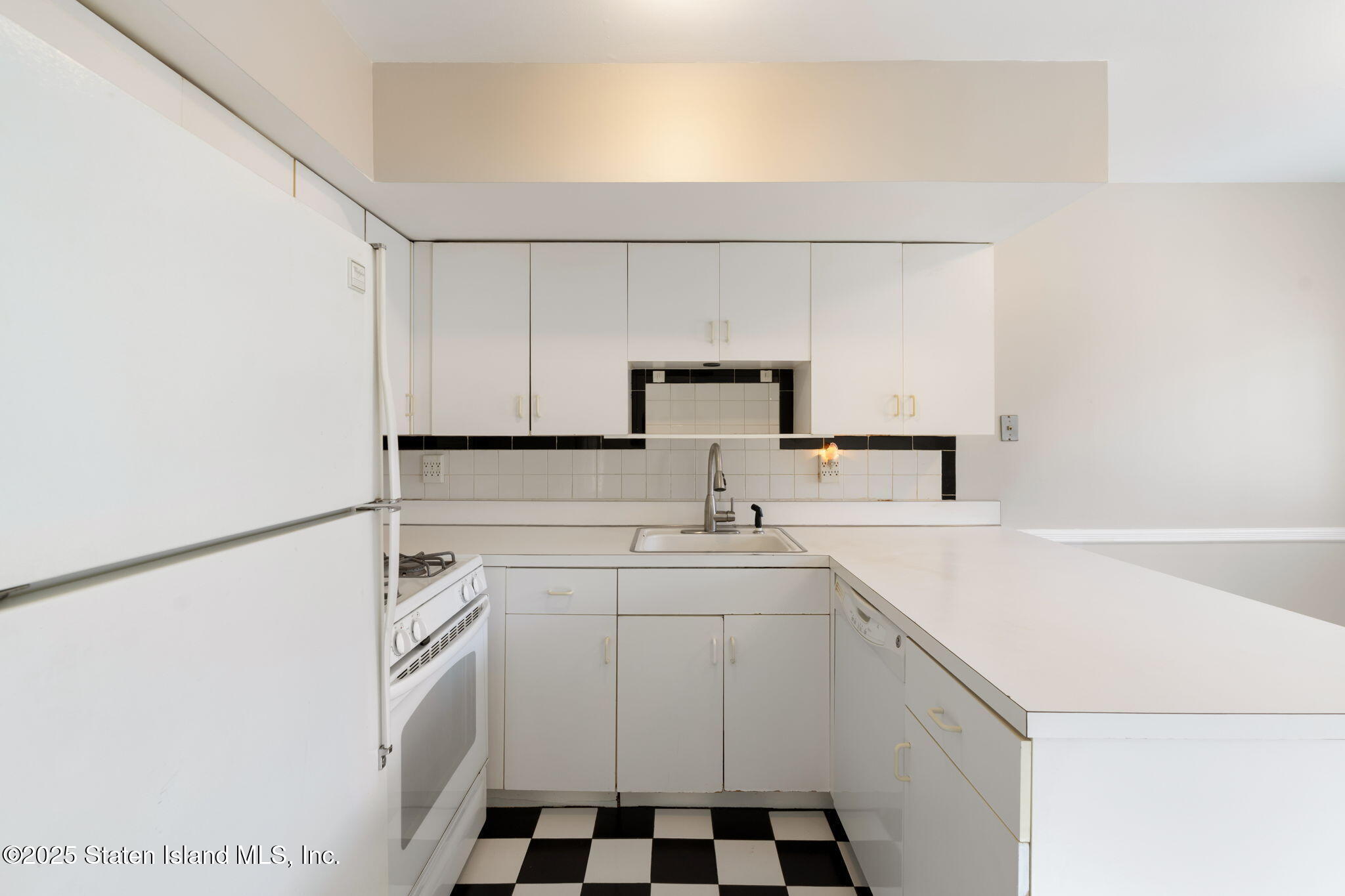 8 Dreyer Avenue, Unit A Staten Island, NY 10314 - Photo 6 of 23 a kitchen with a sink a stove and white cabinets