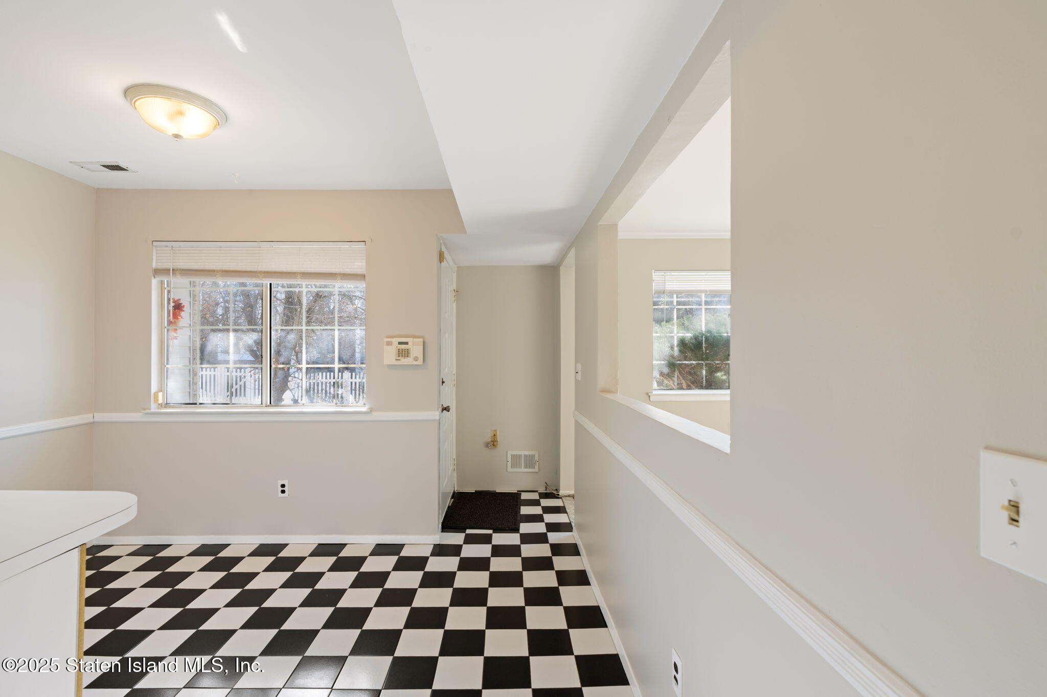 8 Dreyer Avenue, Unit A Staten Island, NY 10314 - Photo 7 of 23 a bathroom with a black white checkered floor and a window