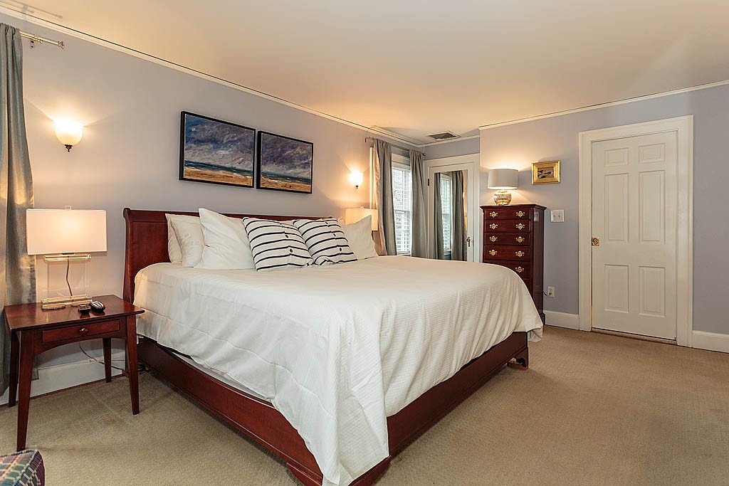 166 Lewis Road Belmont, MA 02478 - Photo 17 of 30 a spacious bedroom with a bed and a lamp with window