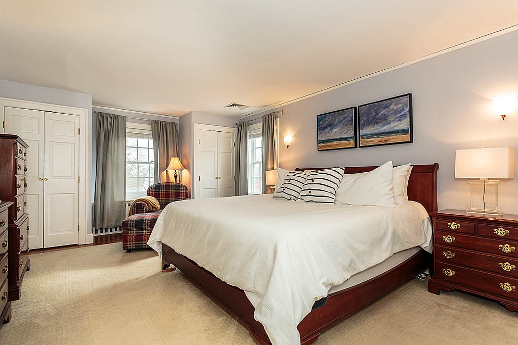 166 Lewis Road Belmont, MA 02478 - Photo 18 of 30 a spacious bedroom with a bed and a lamp