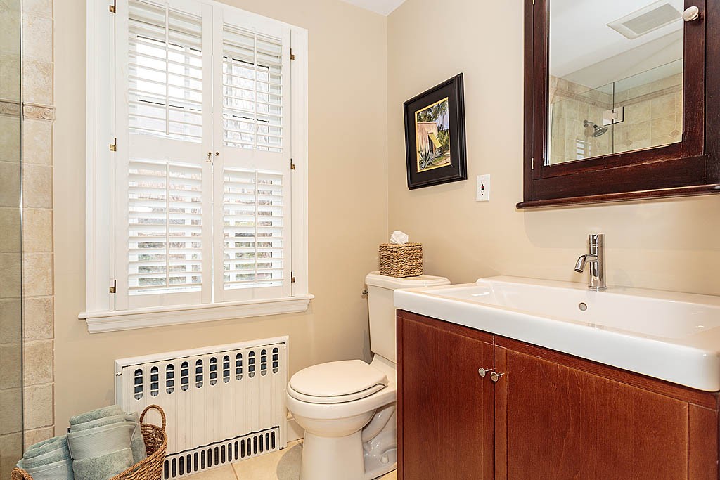 166 Lewis Road Belmont, MA 02478 - Photo 19 of 30 a bathroom with a sink a toilet and a window