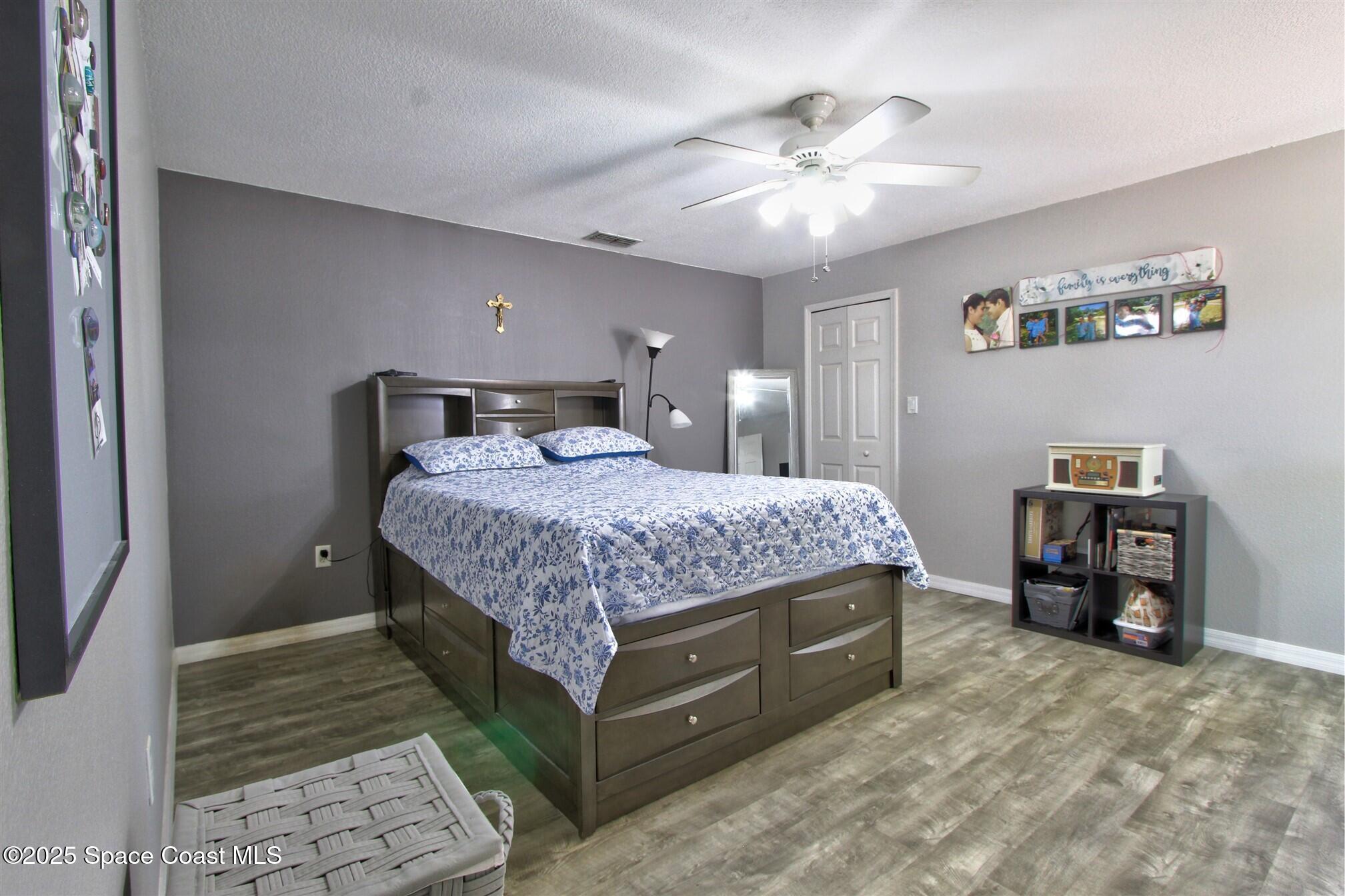 4850 Ancona Road Cocoa, FL 32927 - Photo 11 of 31 a bedroom with a bed and a chandelier