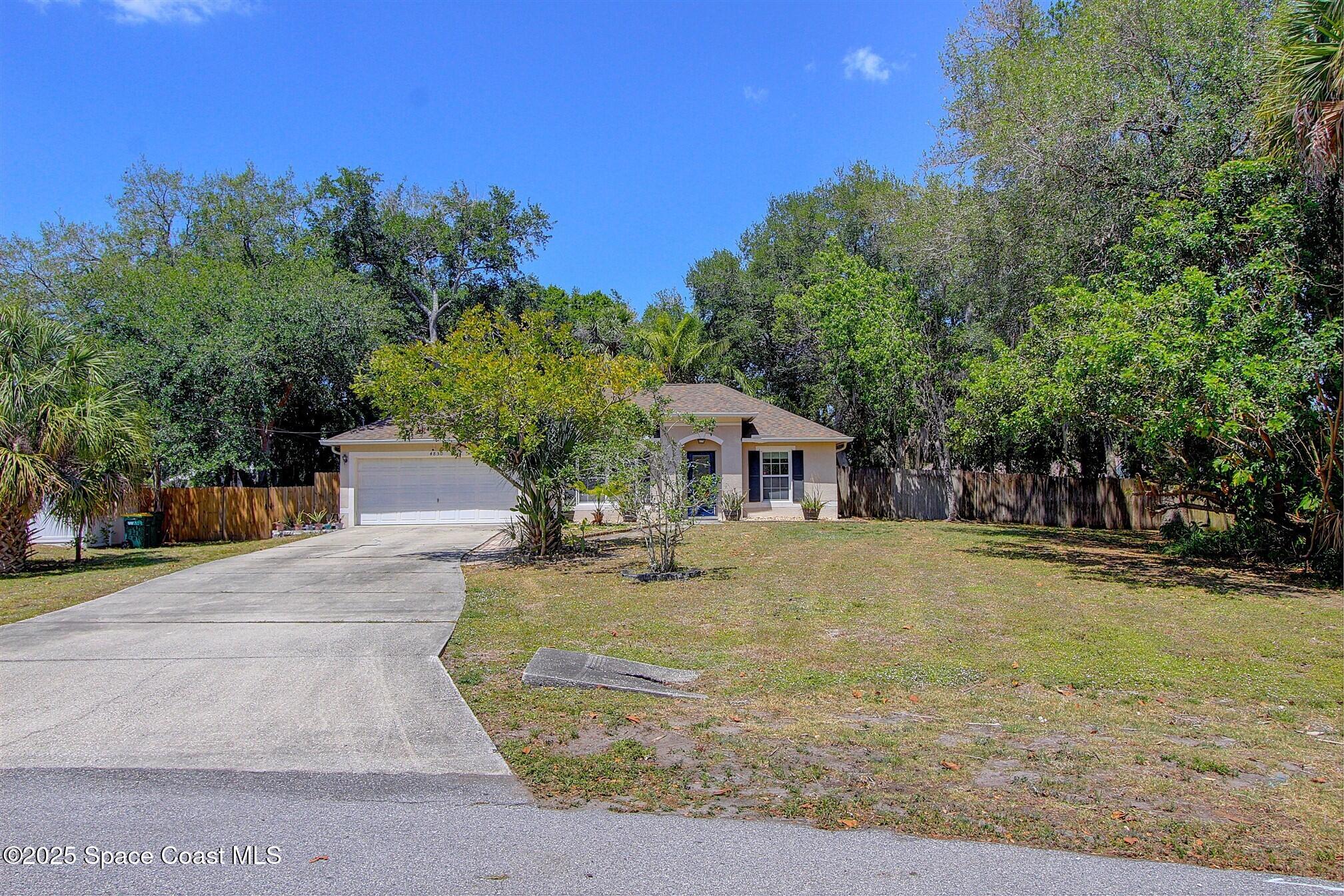4850 Ancona Road Cocoa, FL 32927 - Photo 2 of 31 a front view of a house with a yard
