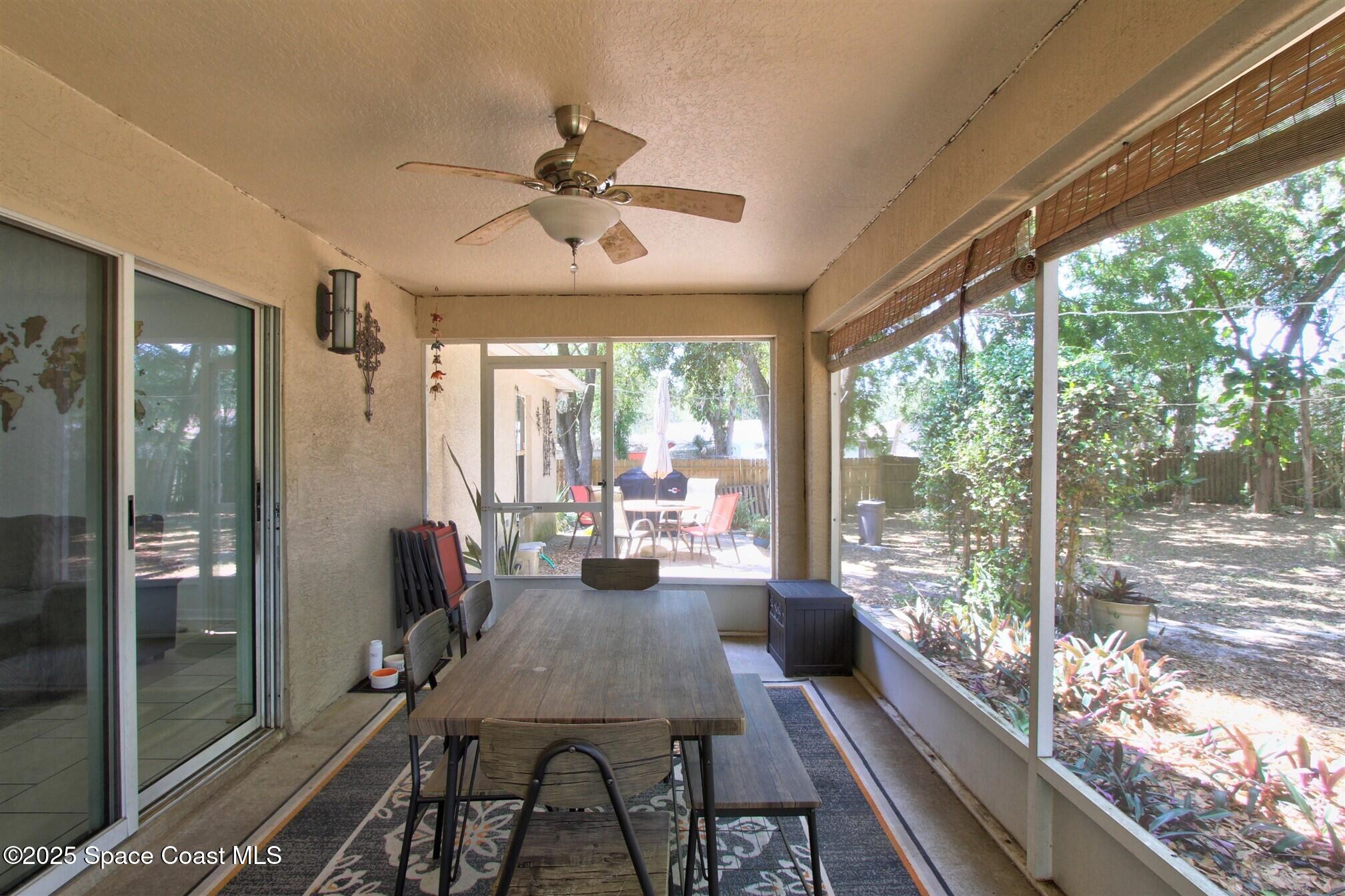 4850 Ancona Road Cocoa, FL 32927 - Photo 23 of 31 a view of a dining room with furniture large windows and wooden floor