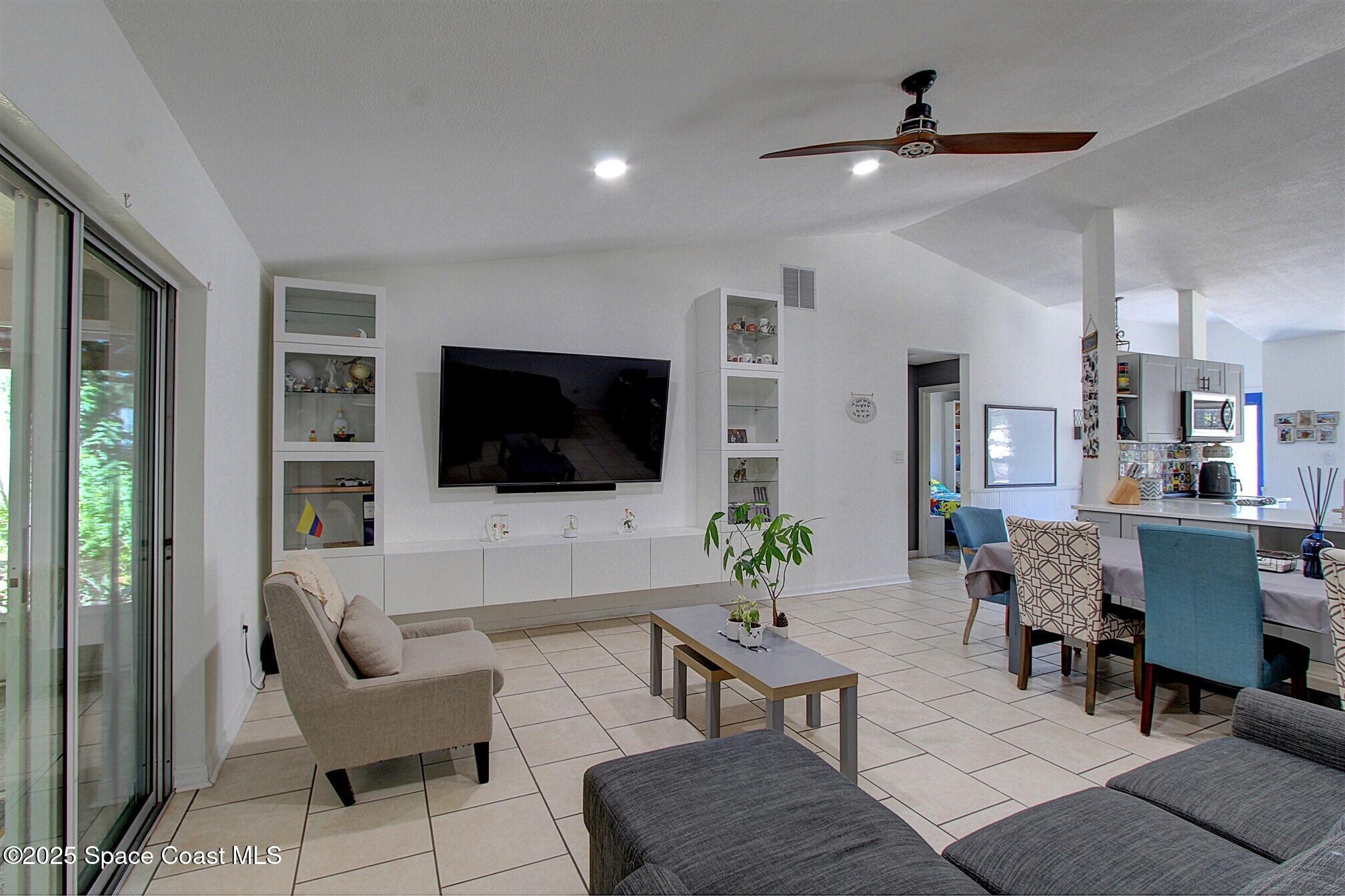 4850 Ancona Road Cocoa, FL 32927 - Photo 8 of 31 a living room with furniture and a flat screen tv