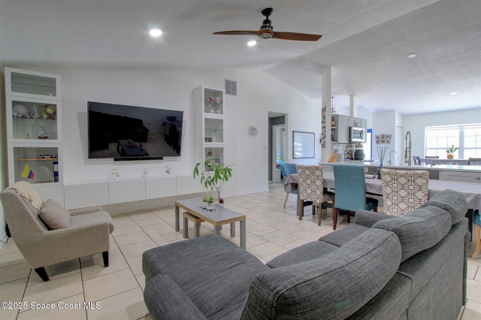4850 Ancona Road Cocoa, FL 32927 - Photo 9 of 31 a living room with furniture and a flat screen tv