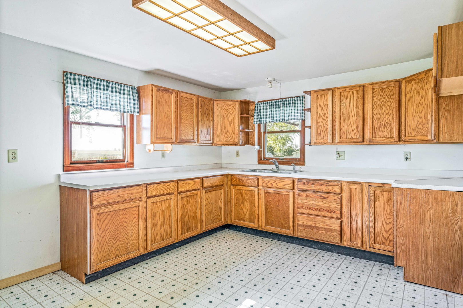 2785 Perry Road Steward, IL 60553 - Photo 4 of 22 a kitchen with granite countertop cabinets a sink a window and stainless steel appliances