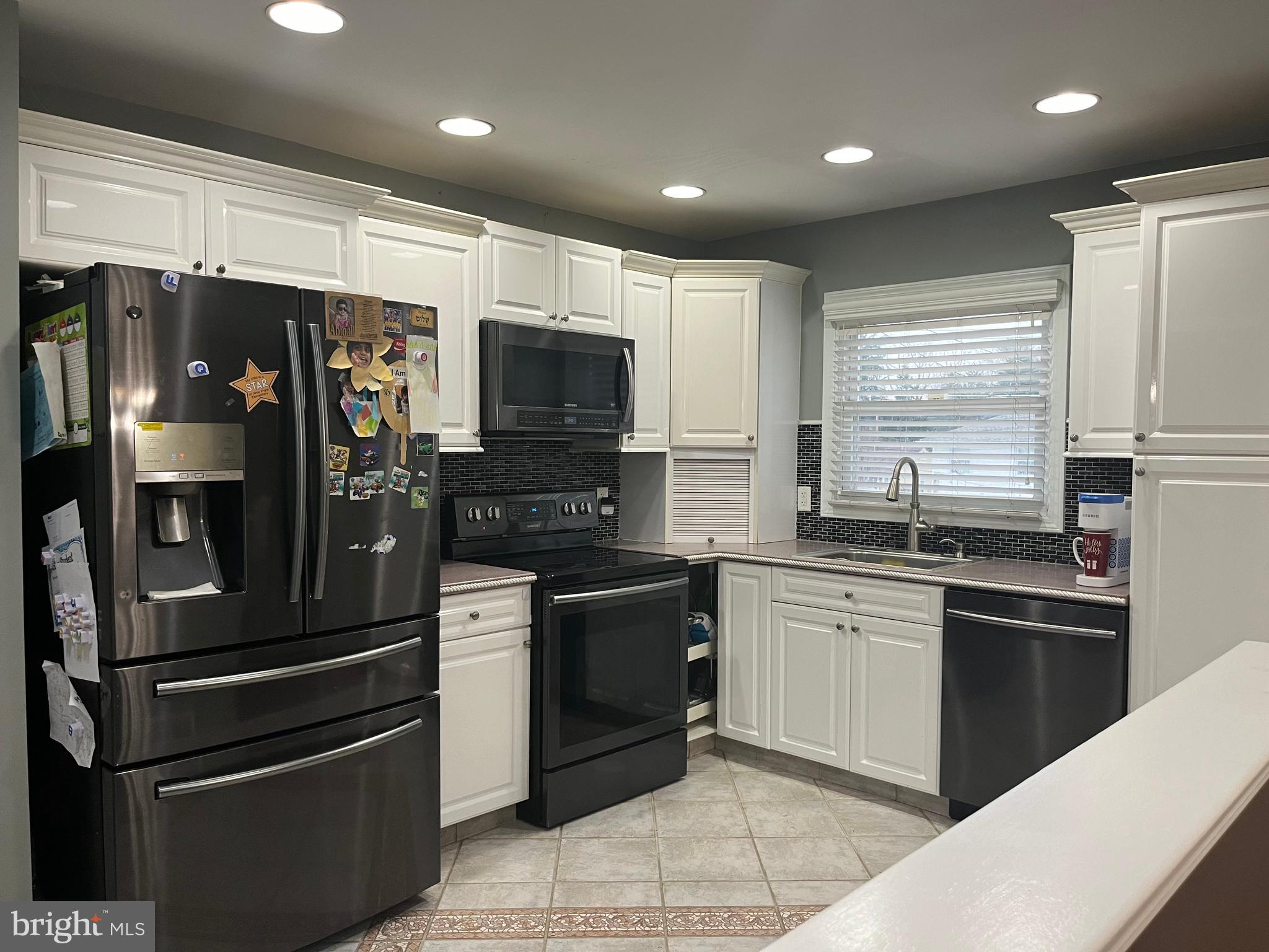 1006 Susan Road Philadelphia, PA 19115 - Photo 12 of 37 a kitchen with stainless steel appliances kitchen island granite countertop a refrigerator stove and sink