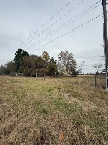 a view of a field with an ocean view