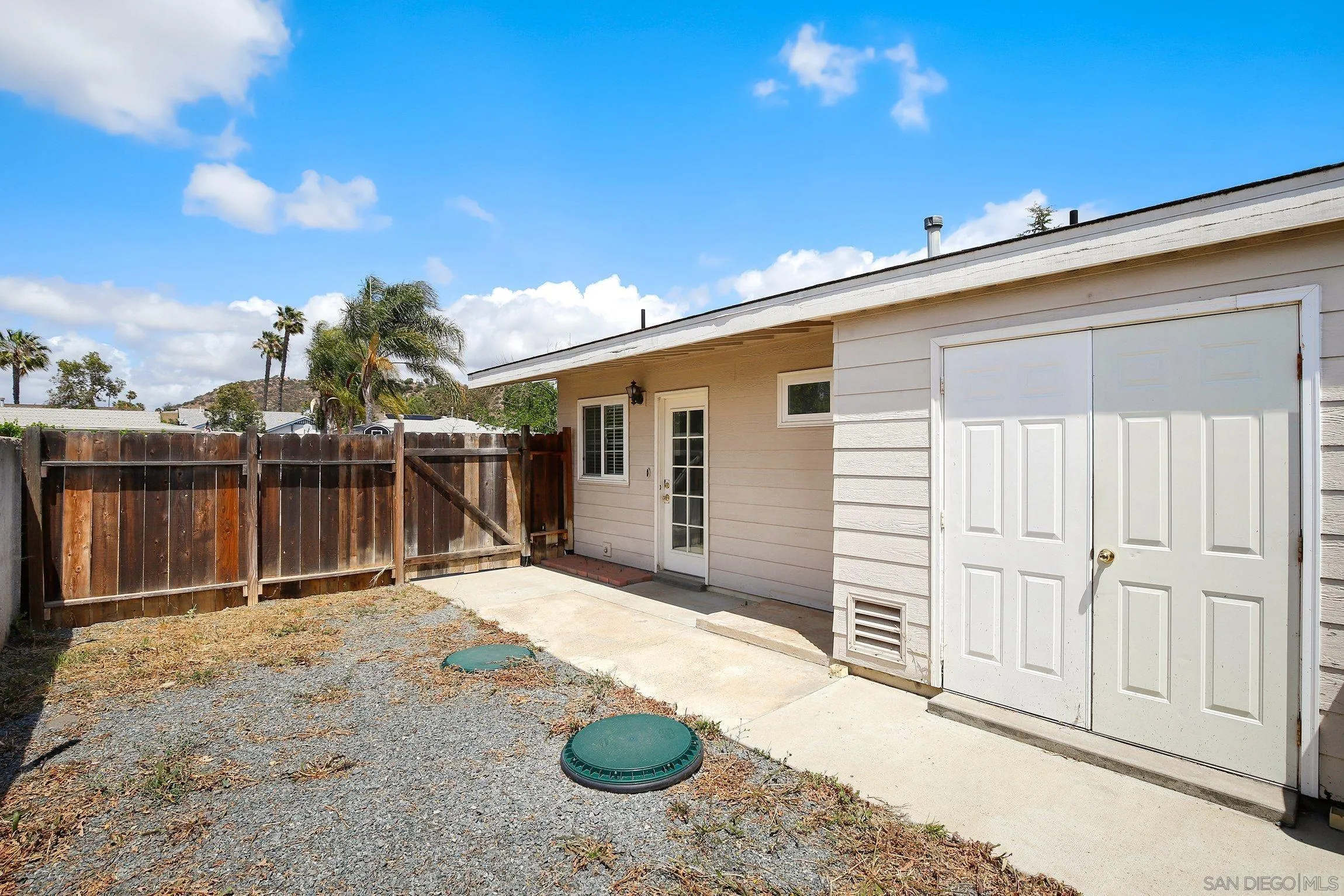 13647 Somerset Road Poway, CA 92064 - Photo 16 of 25 a view of backyard with tub and wooden fence