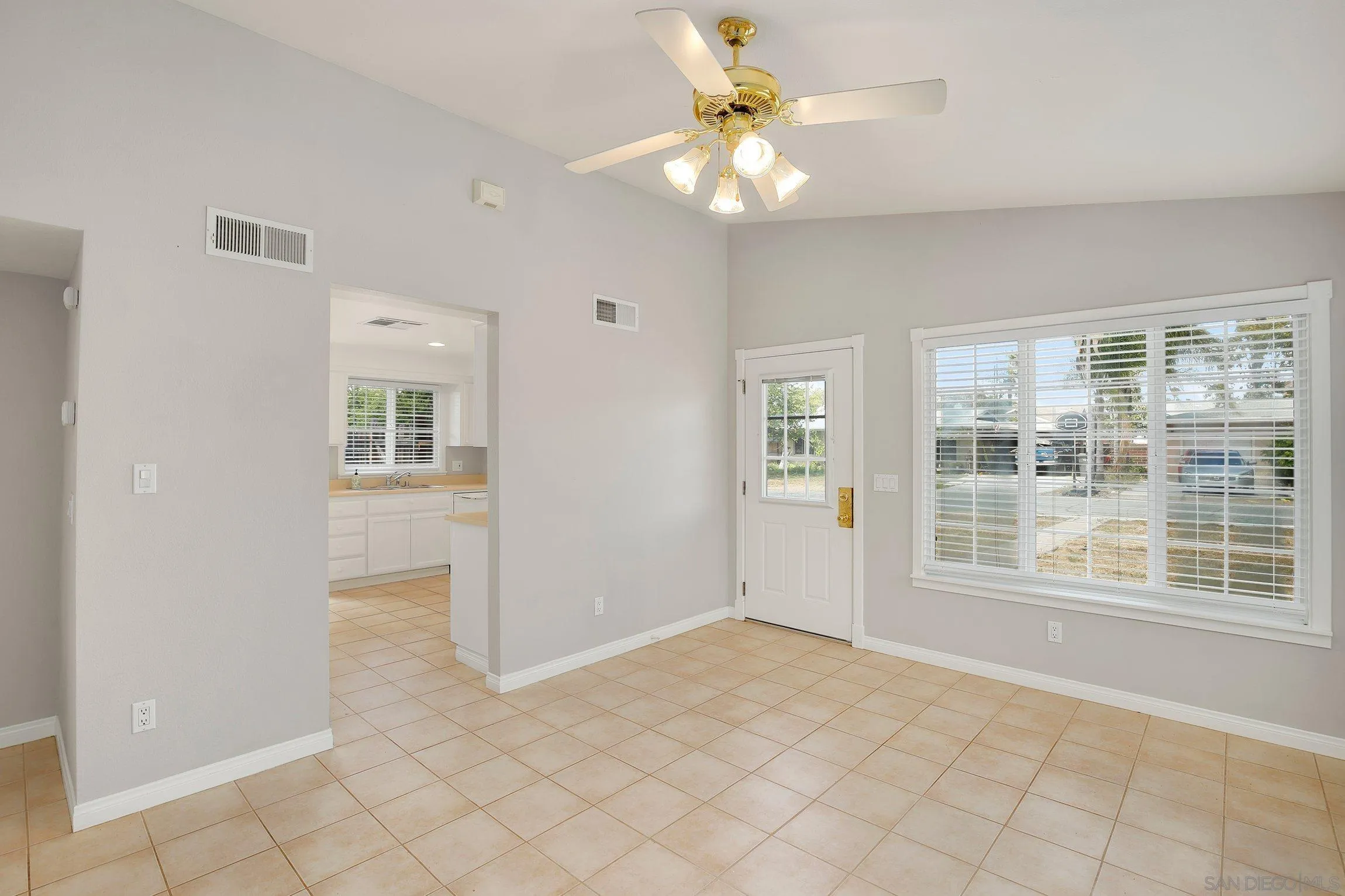 13647 Somerset Road Poway, CA 92064 - Photo 6 of 25 an empty room with chandelier fan and windows